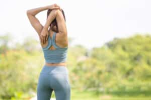 Arizona woman stretches outdoors, experiencing no pain after undergoing lumbar sympathetic block treatment.