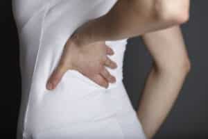 Close up cropped shot of young woman with hand on back