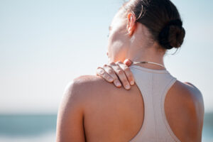 tired shoulder pain and fitness with woman at bea 2025 04 06 08 45 08 utc